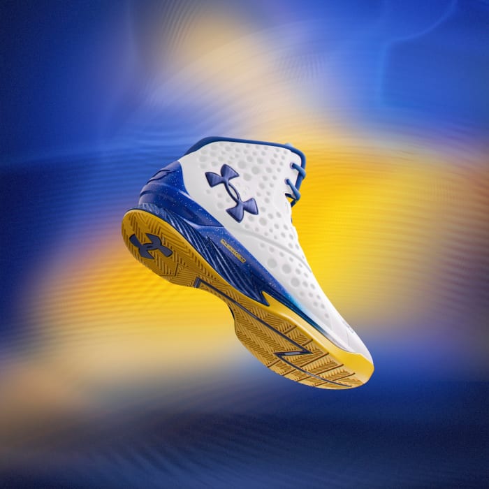 Side view of Stephen Curry's white, blue, and gold Under Armour sneakers.